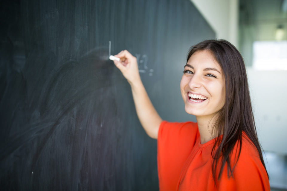student at chalkboard