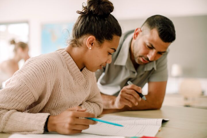 High school student getting support from her instructor.